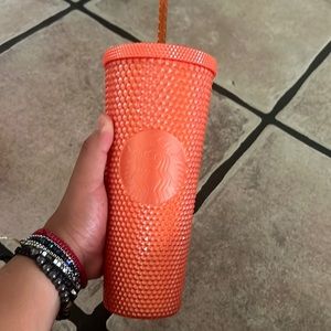 Orange studded Starbucks cup